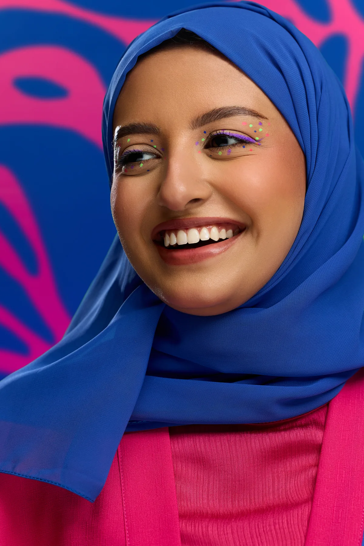 Smiling beauty model in a blue hijab wearing purple eyeshadow for the Sephora Ramadan campaign